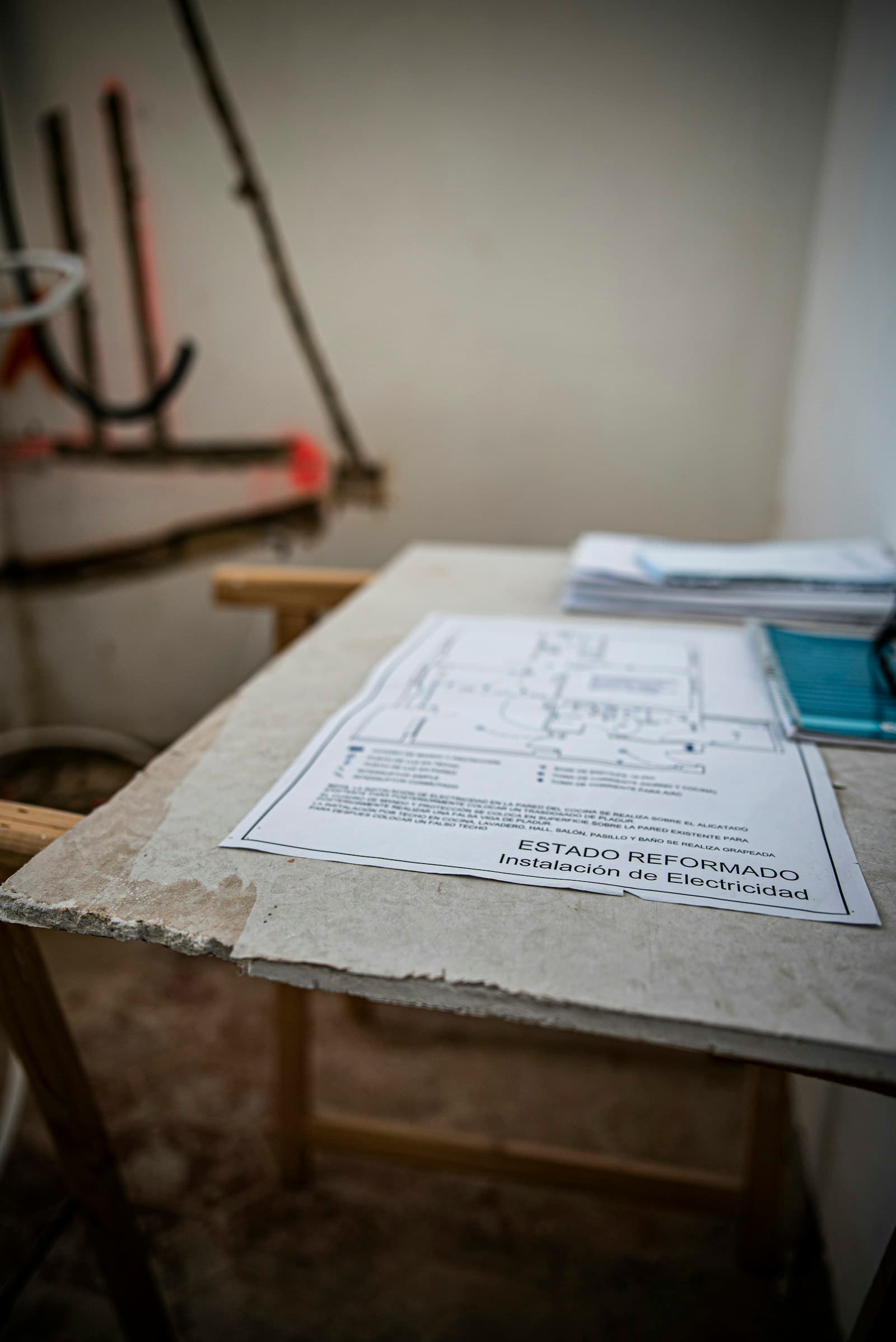 Building plans laid out on a worktable in a quiet workshop