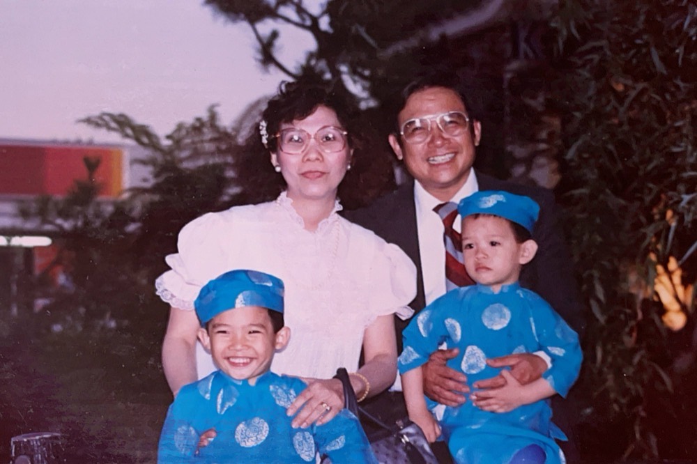 A family photograph: my parents with two small boys in blue áo dài